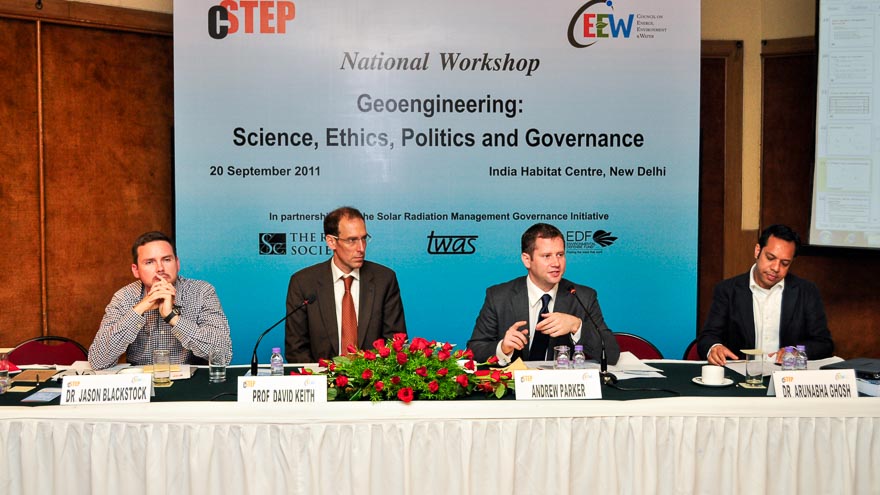 Four men speaking on a panel